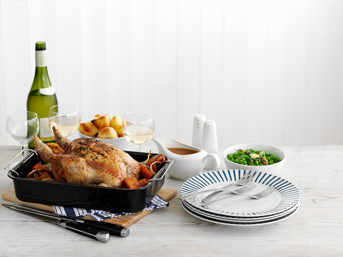 Roast turkey with various side dishes and glasses of wine