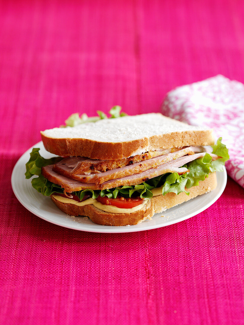A sandwich with ham and salad