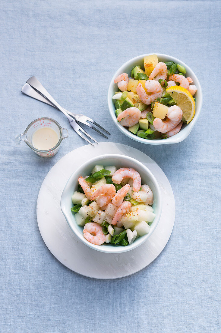 Two prawn cocktails with avocado, turnip and melon