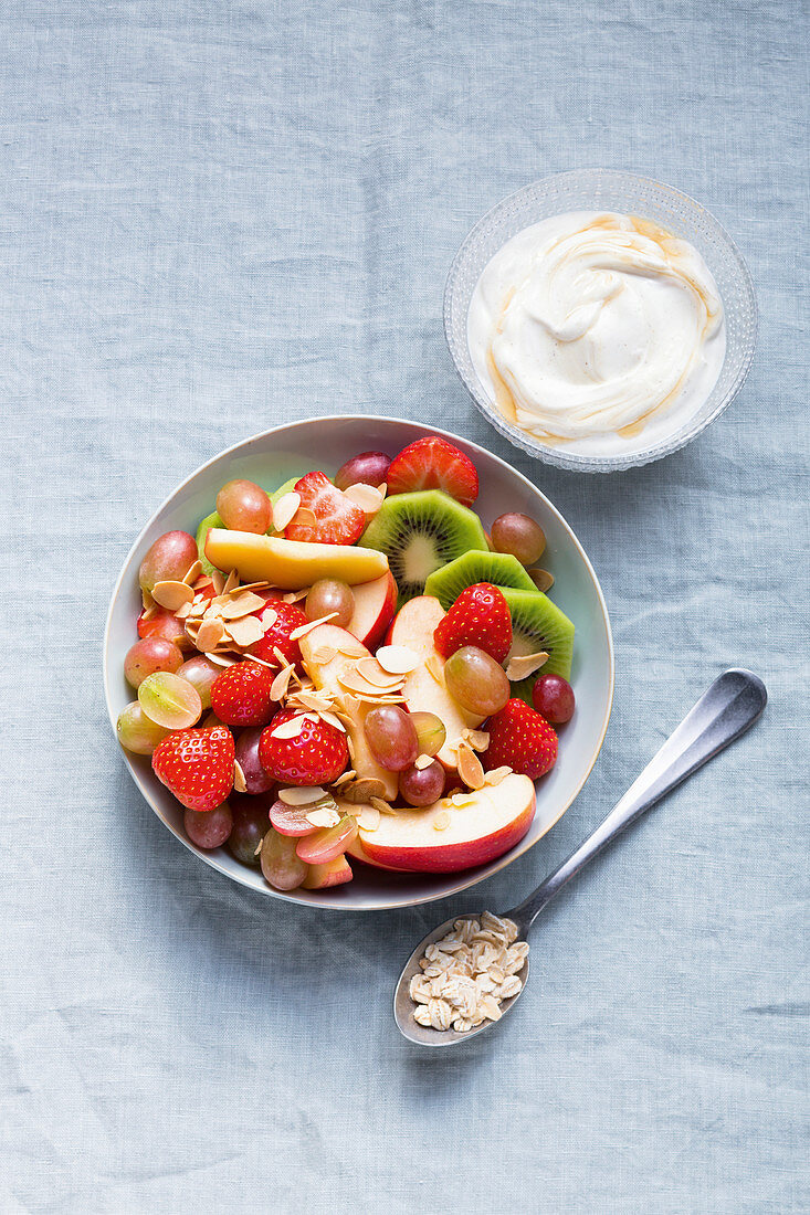 Fruit salad with flaked almonds and vanilla quark