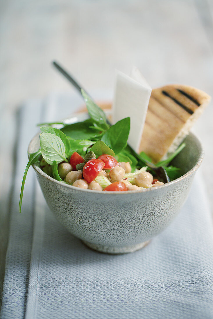 Chickpea salad with tomatoes, basil and unleavened bread