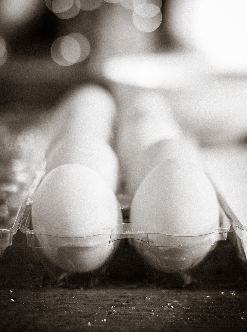 White eggs in a transparent egg holder (close-up)