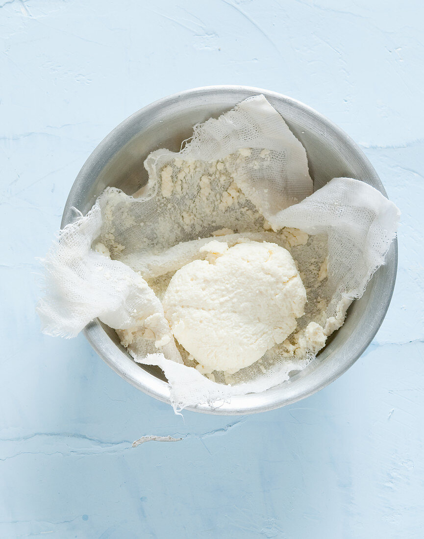 Homemade cream cheese in a muslin cloth (seen from above)