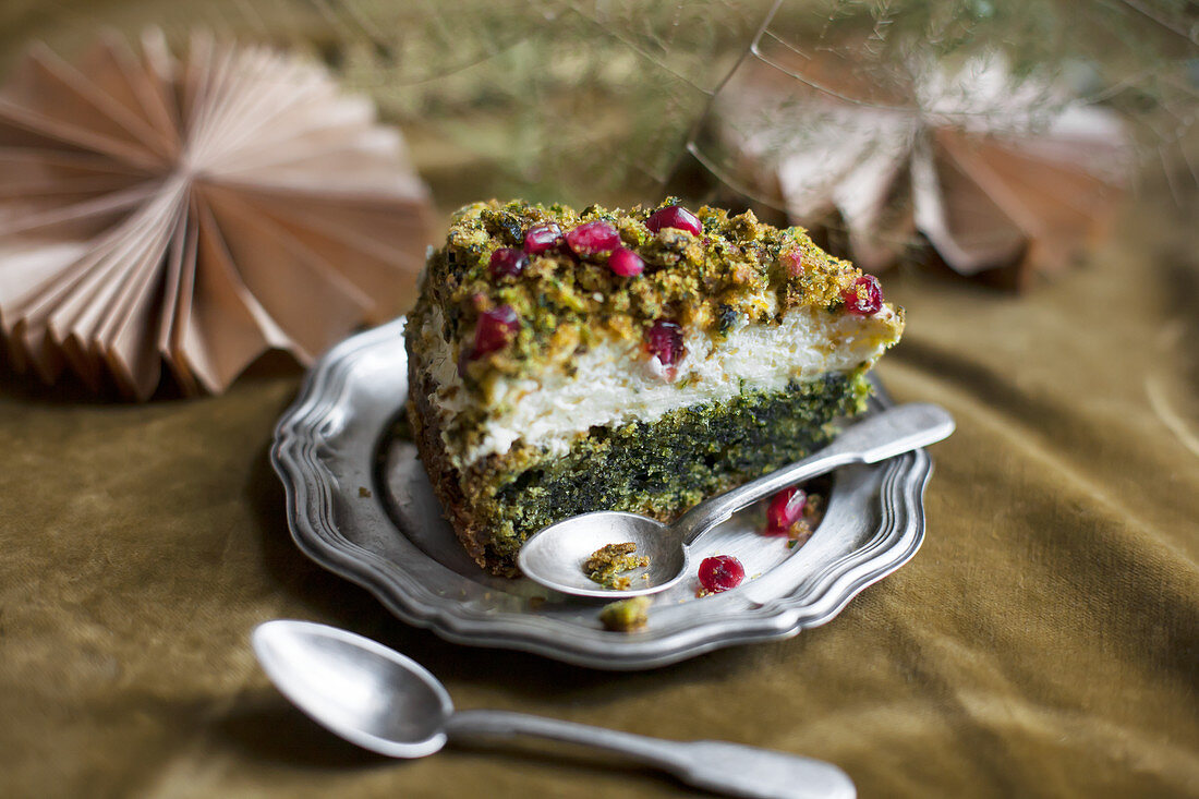 A slice of spinach cake with pomegranate seeds