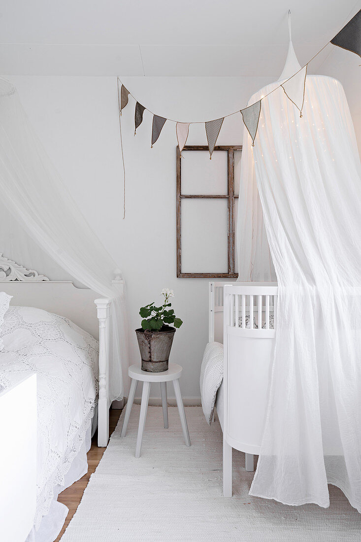 Cot with illuminated canopy in parent's bedroom