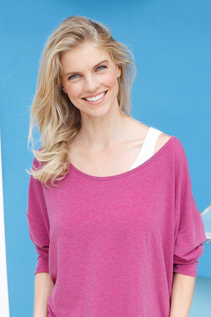 A blonde woman wearing a purple blouse