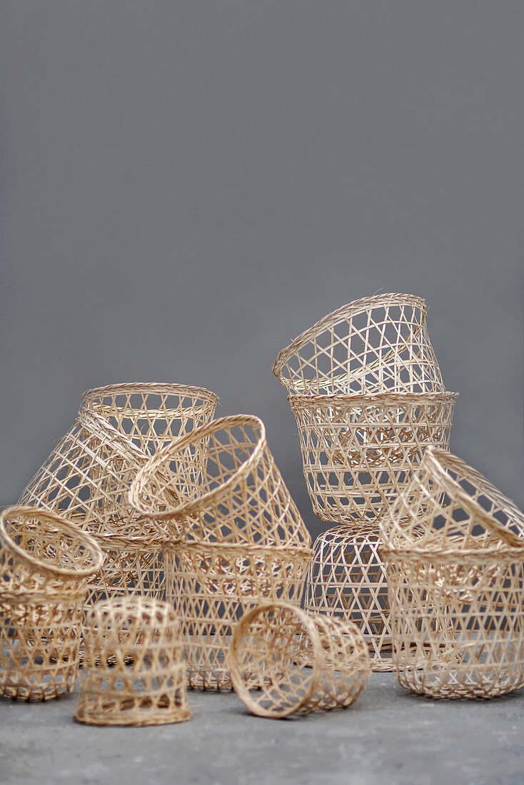 Collection of baskets of various sizes against grey wall