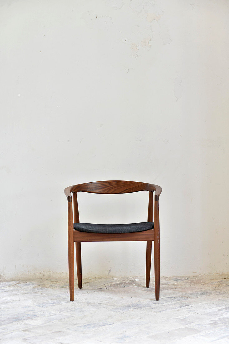 Scandinavian wooden chair against white wall