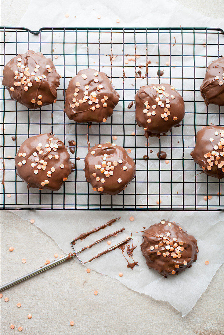 Chocolate-coated oat biscuits with sugar sprinkles