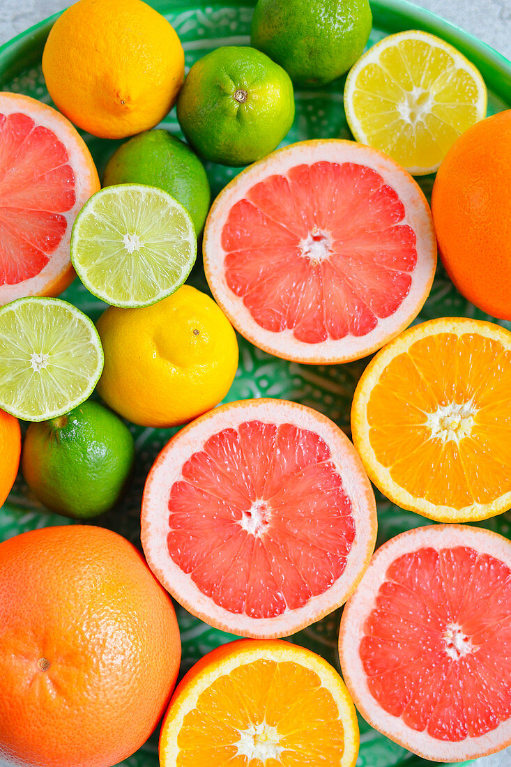 Oranges grapefruit limes lemons on a tray cocktail citrus