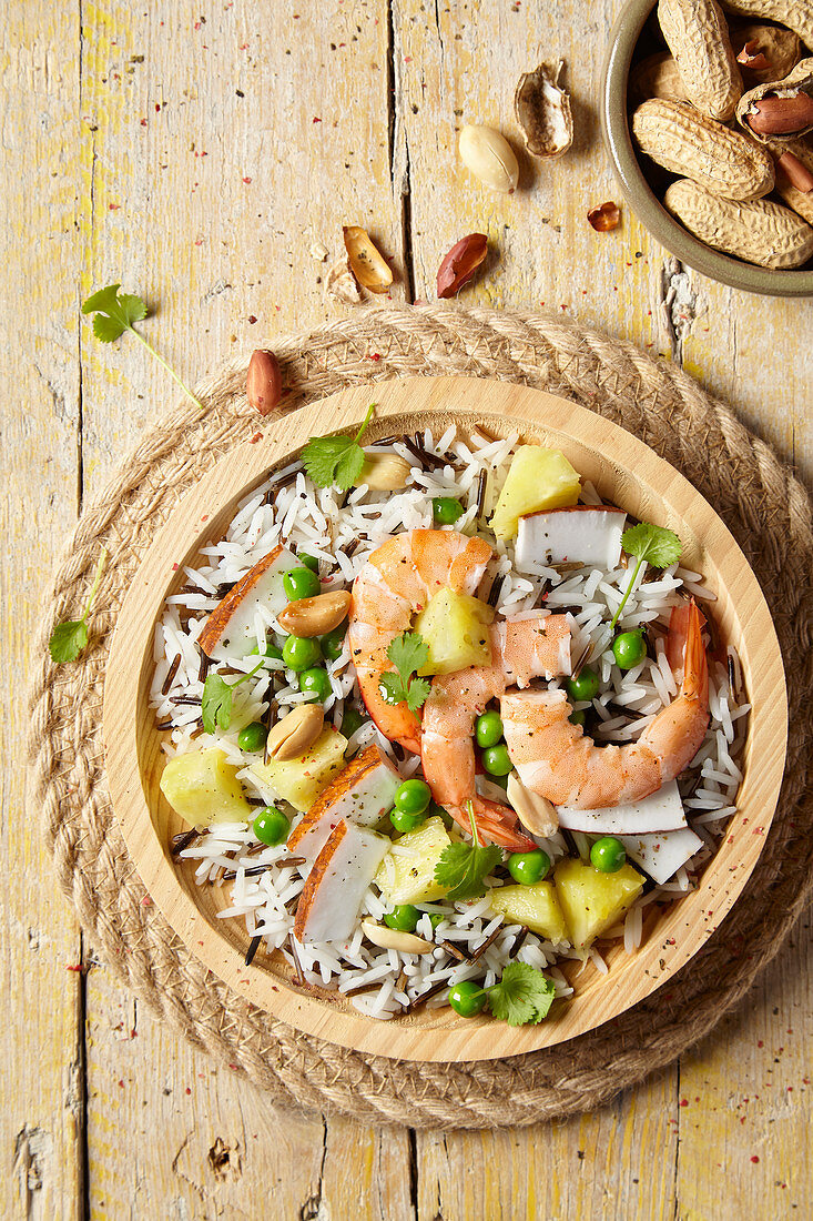 Rice salad with prawns, peas, pineapple and coconut shavings