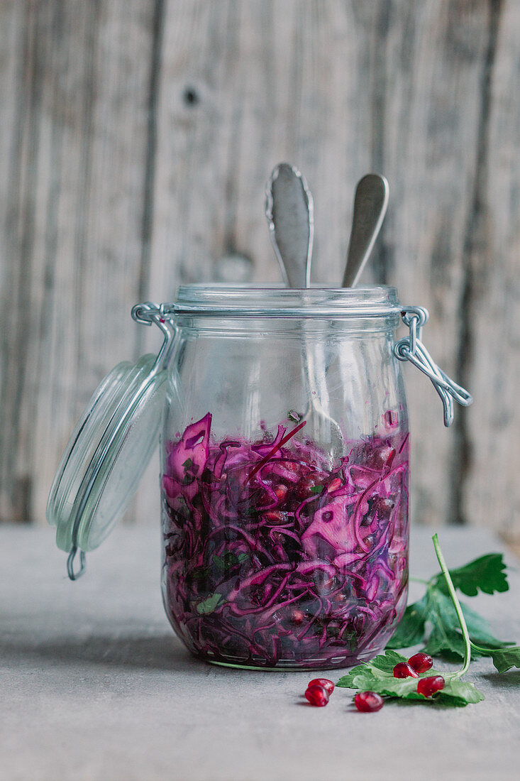 Red cabbage salad with pomegranate seeds in a jar