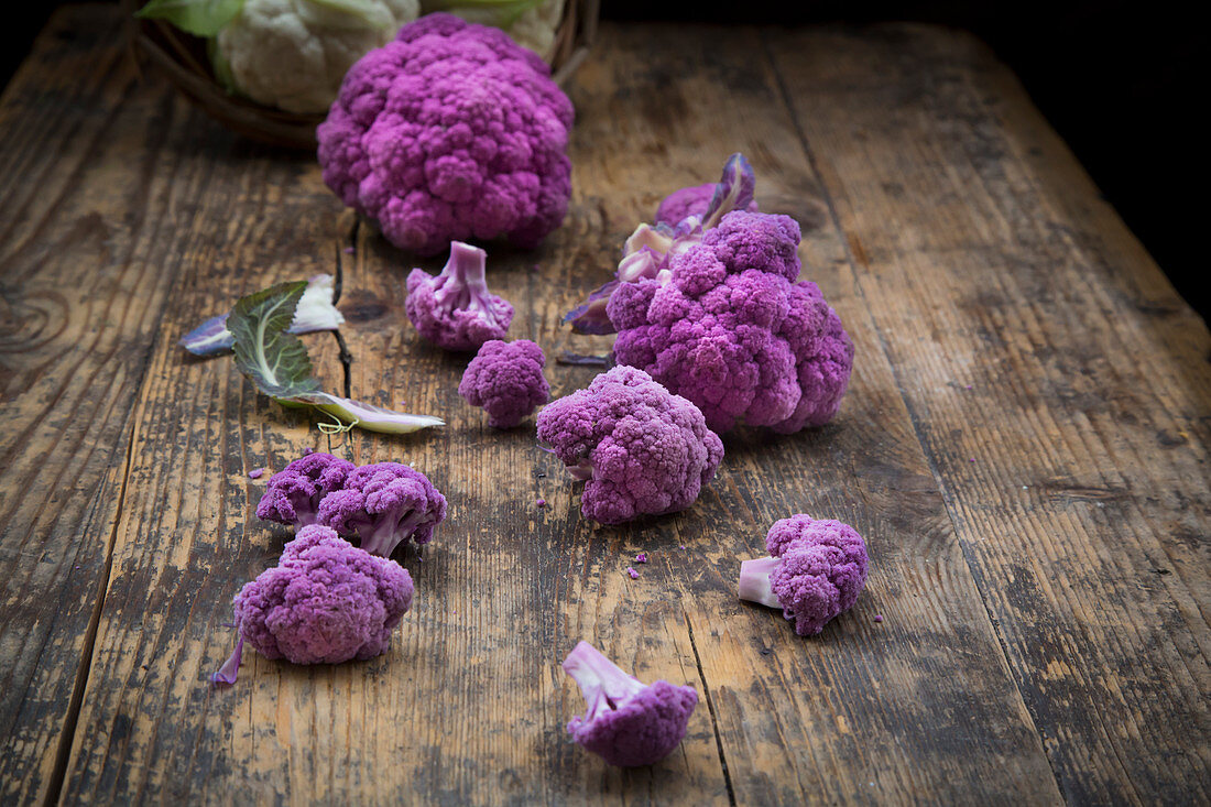 Purple organic cauliflower on a wooden surface