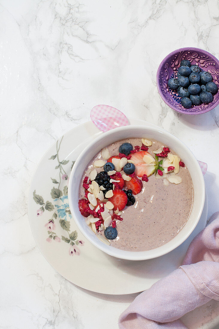 A breakfast bowl with acai berries and almond flakes