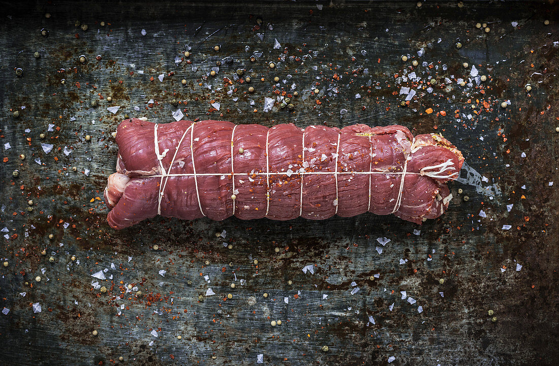 Raw beef roulade, twine, salt and spices