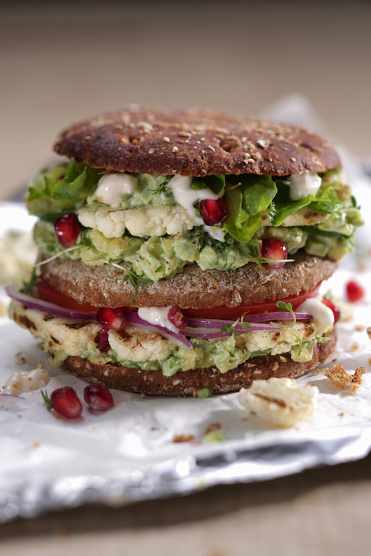 Veggie burger with cauliflower and pomegranate seeds