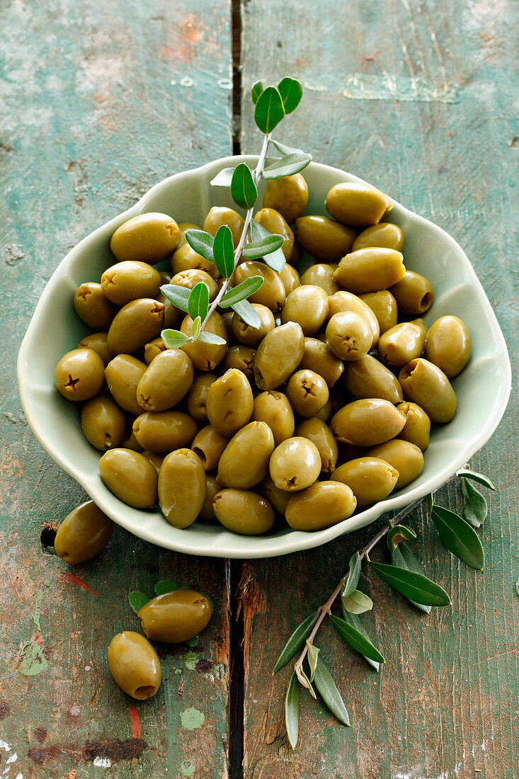 Green olives in a ceramic bowl