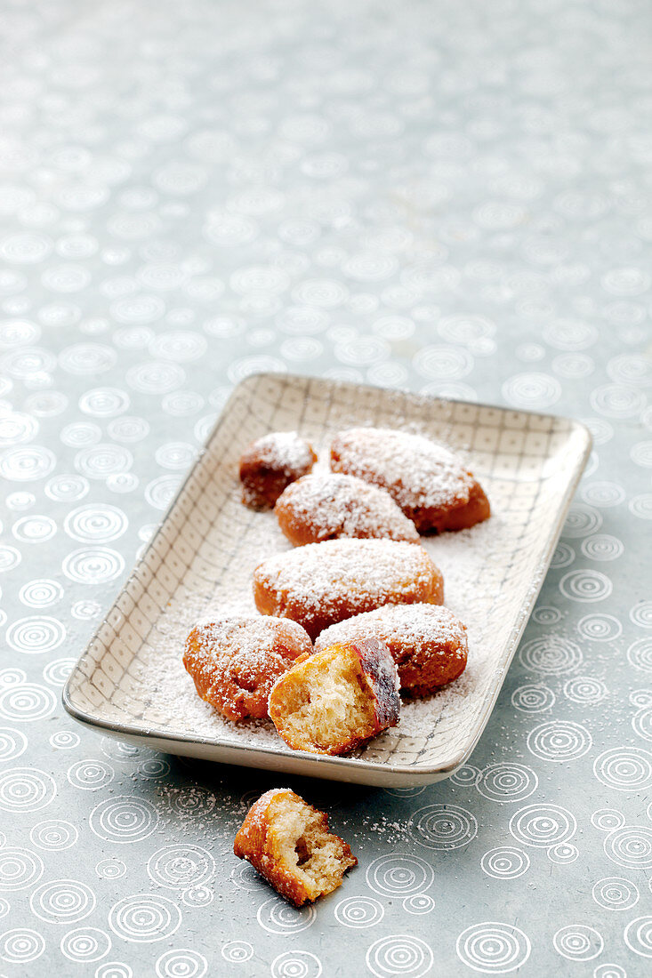 Homemade deep-fried pastries with icing sugar
