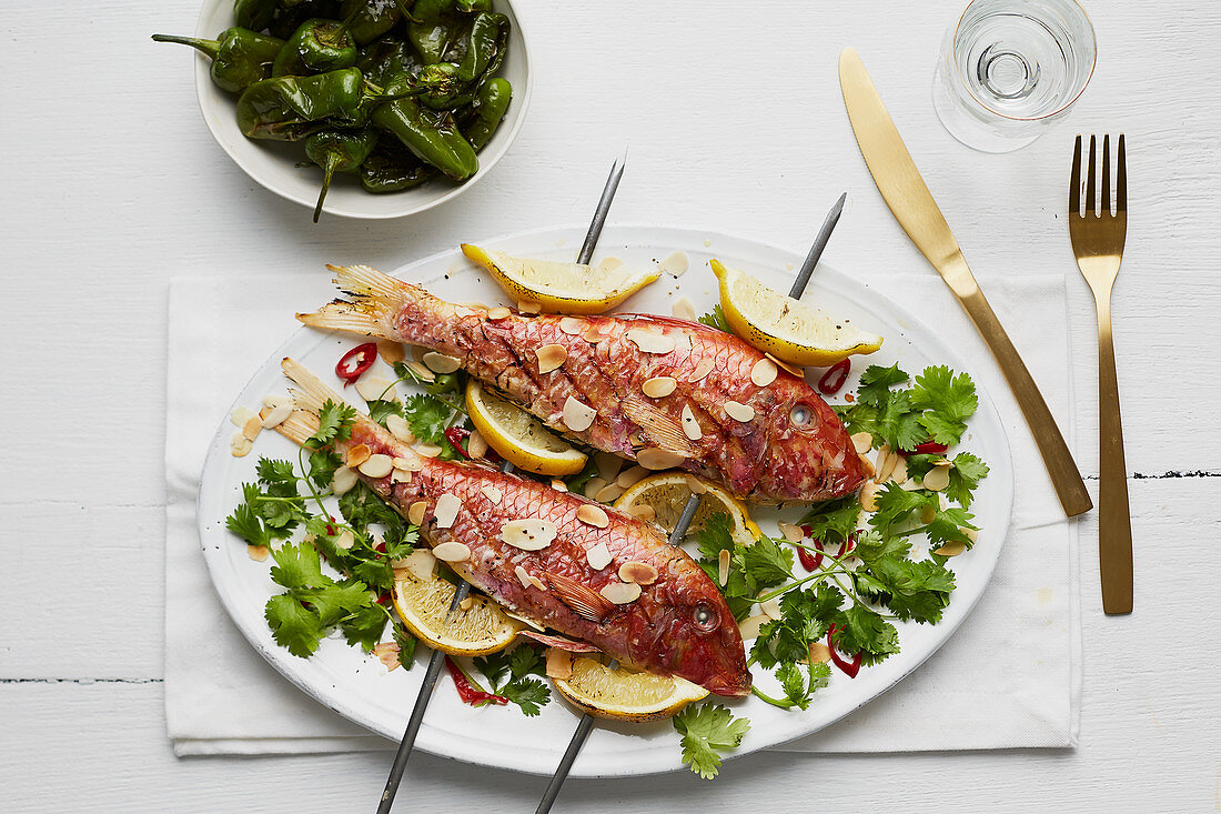 Grilled red snapper with lemons and flaked almonds on skewers