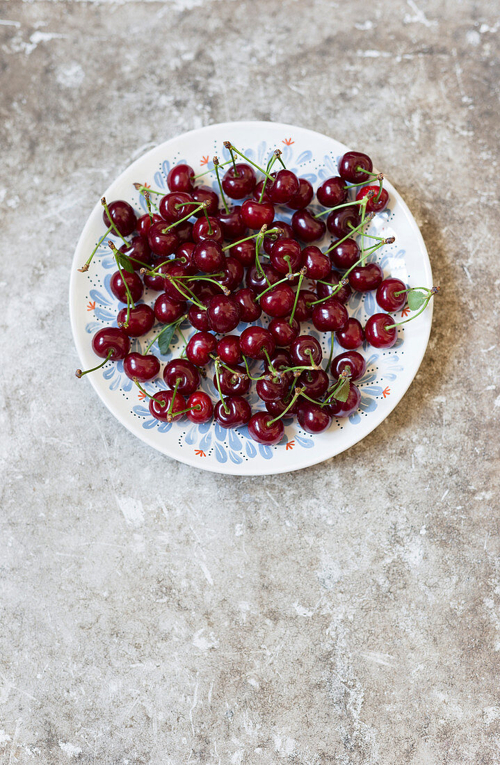 Dark red cherries on a plate