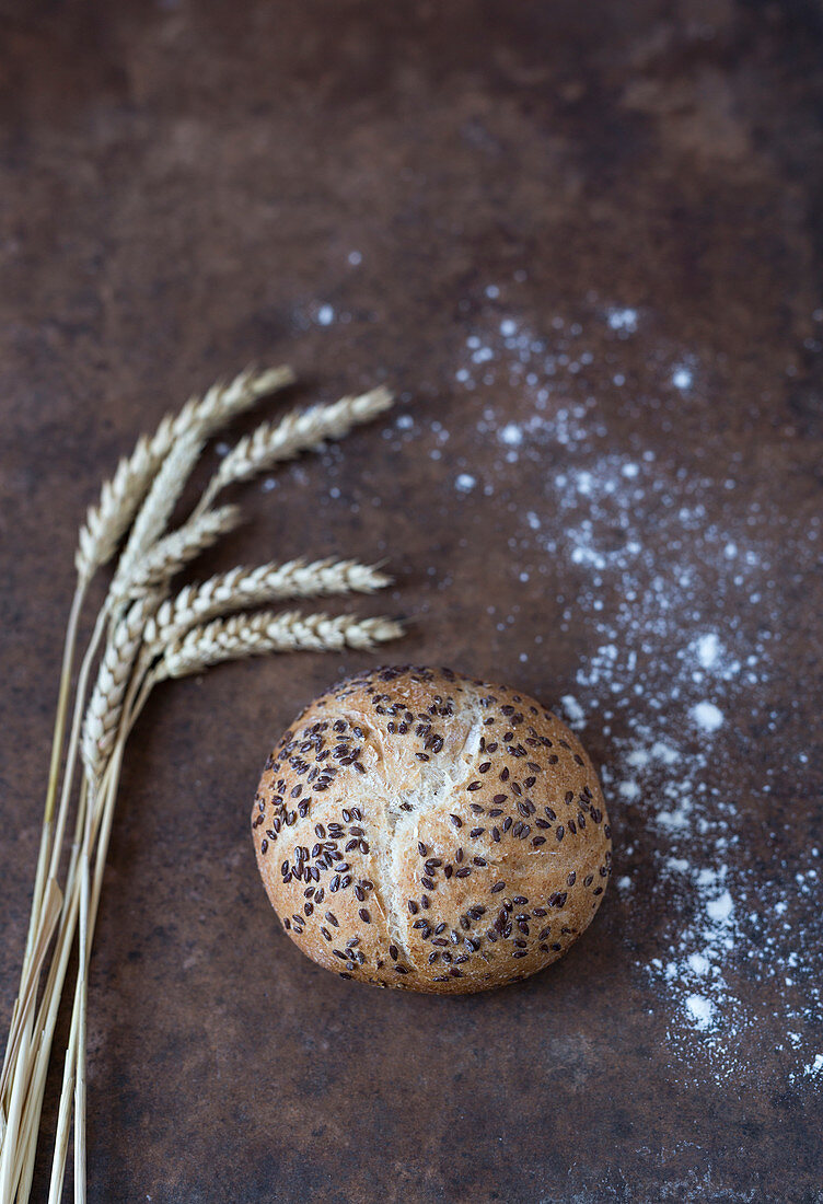 A wheat bread roll with black sesame seeds