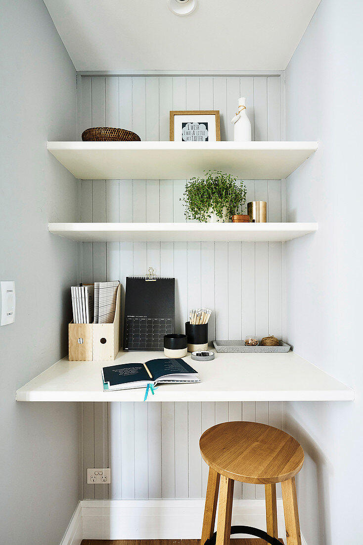 Small workspace with shelves, desk top and wooden stool