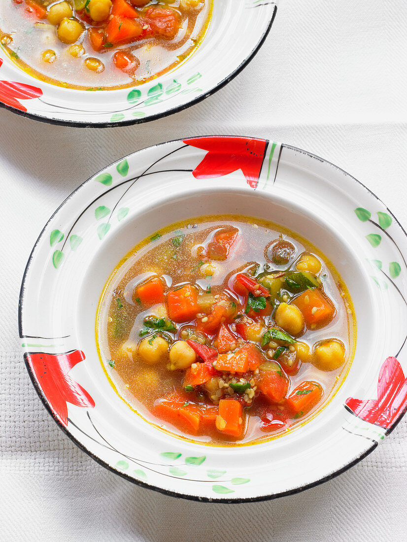 Chickpea soup with zucchini, carrots, chili, cumin and tomatoes