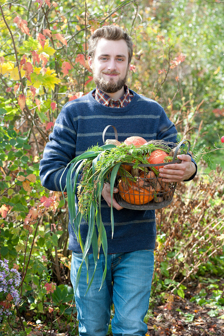 Man Bringing Basket With Freshly Harvested Vegetables