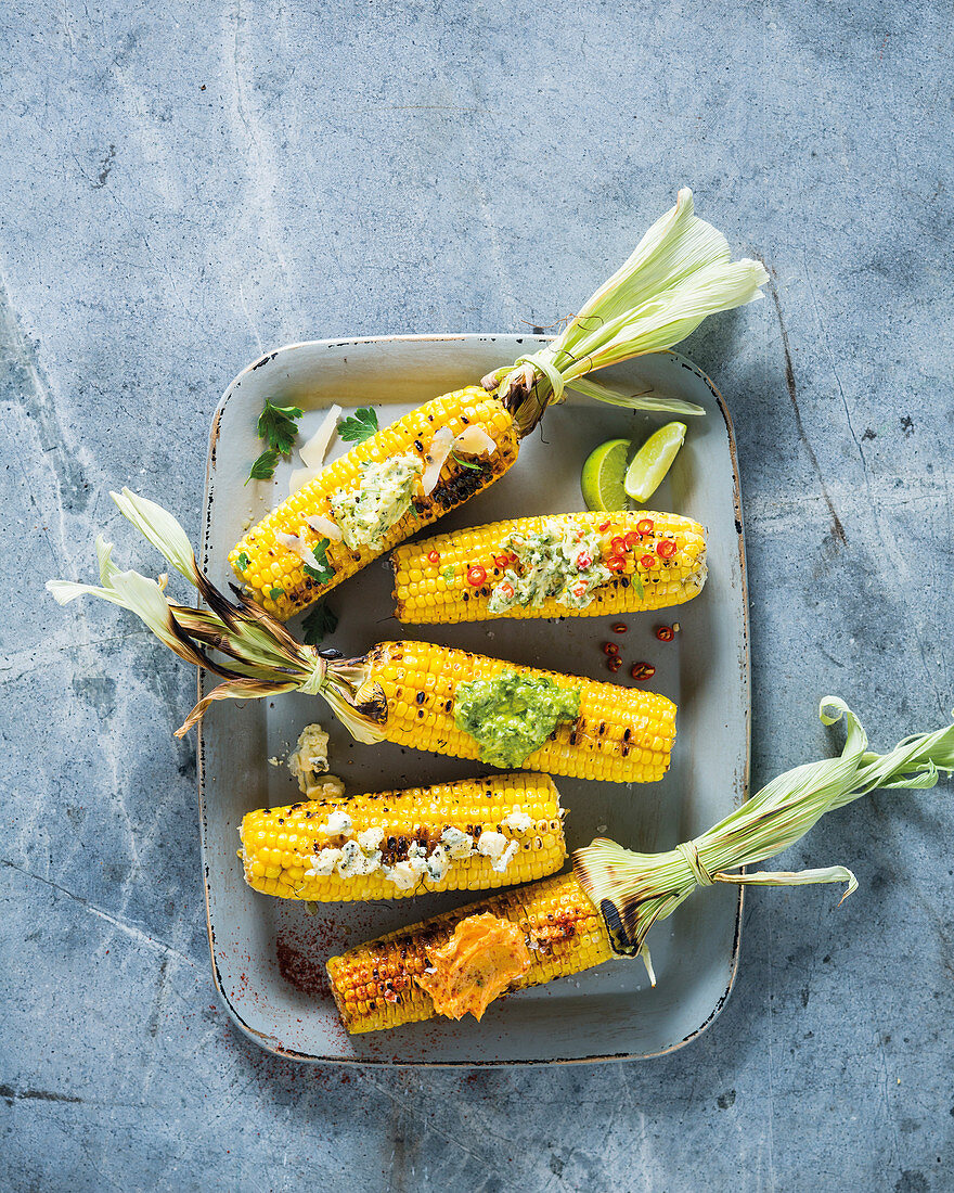 Grilled corncobs with spiced butter variations