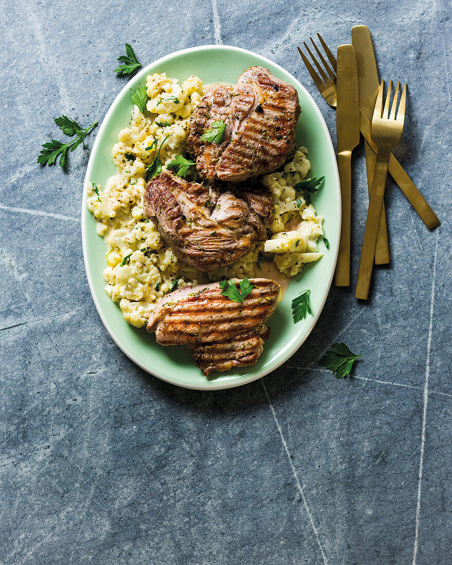 Pork chops on creamy crushed cauliflower