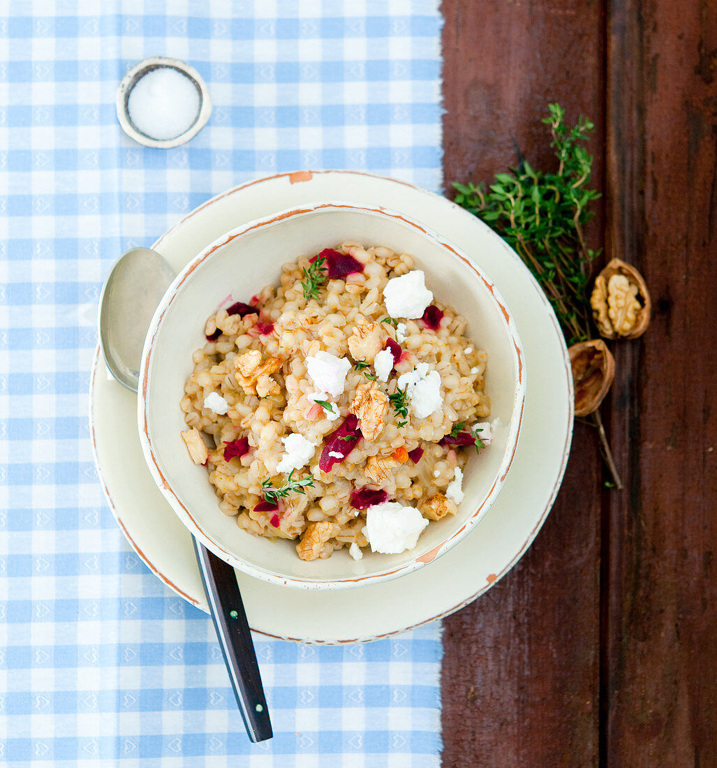 Wheat risotto with feta cheese, thyme and walnuts