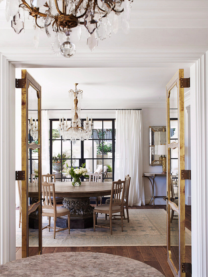 Glance into the dining room with a round table and antique, Gustavian chairs