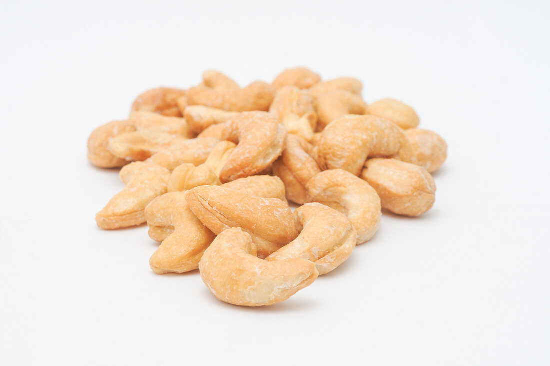 Salted cashews on a white surface