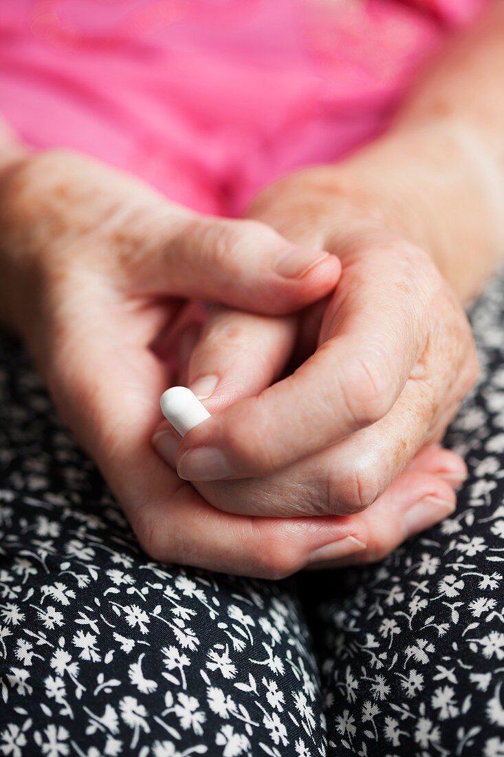 Elderly woman taking a pill