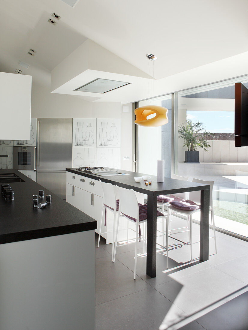 Island counter and glass wall in modern designer kitchen