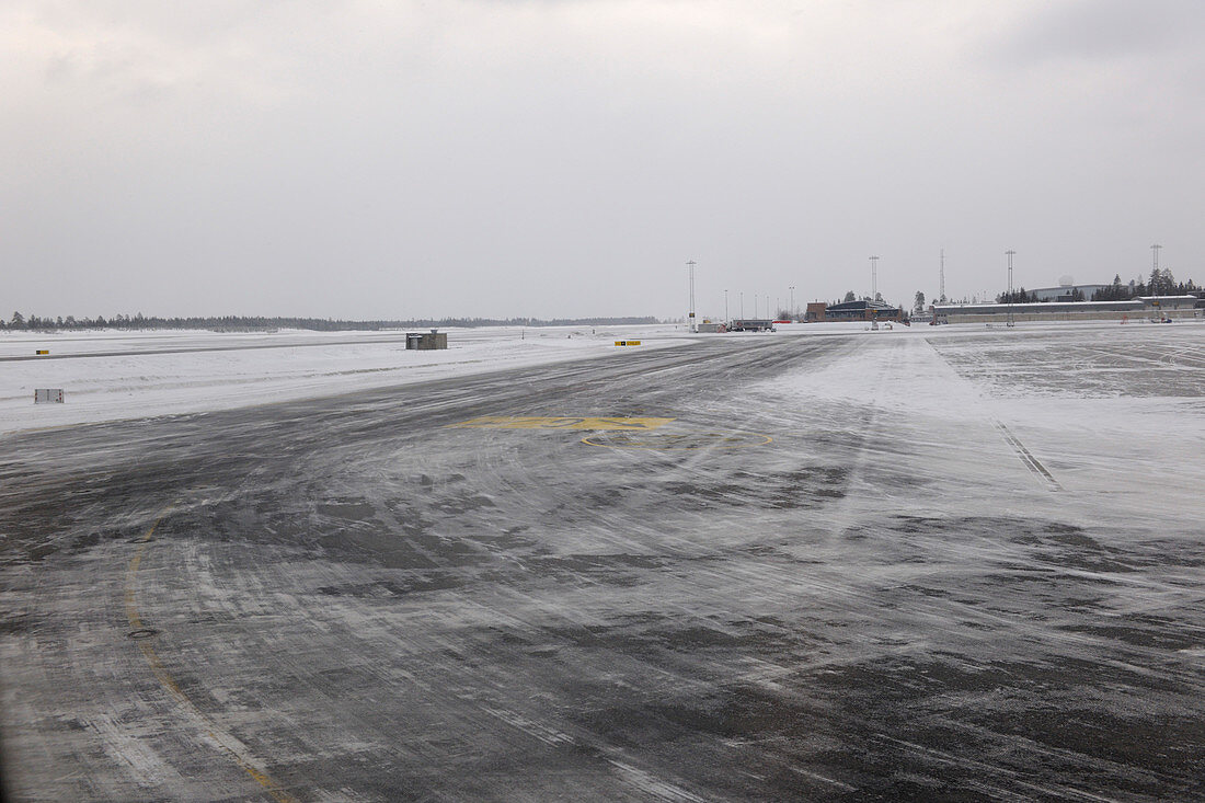 Snow on airport taxiway