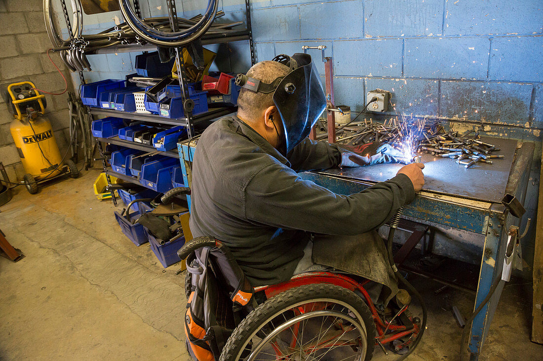 Disabled worker welding, Mexico