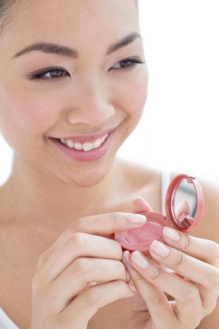 Woman applying make up