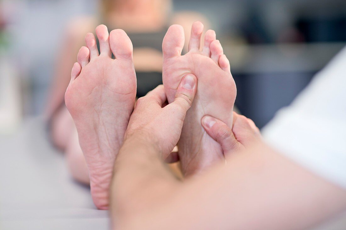 Person massaging woman's feet