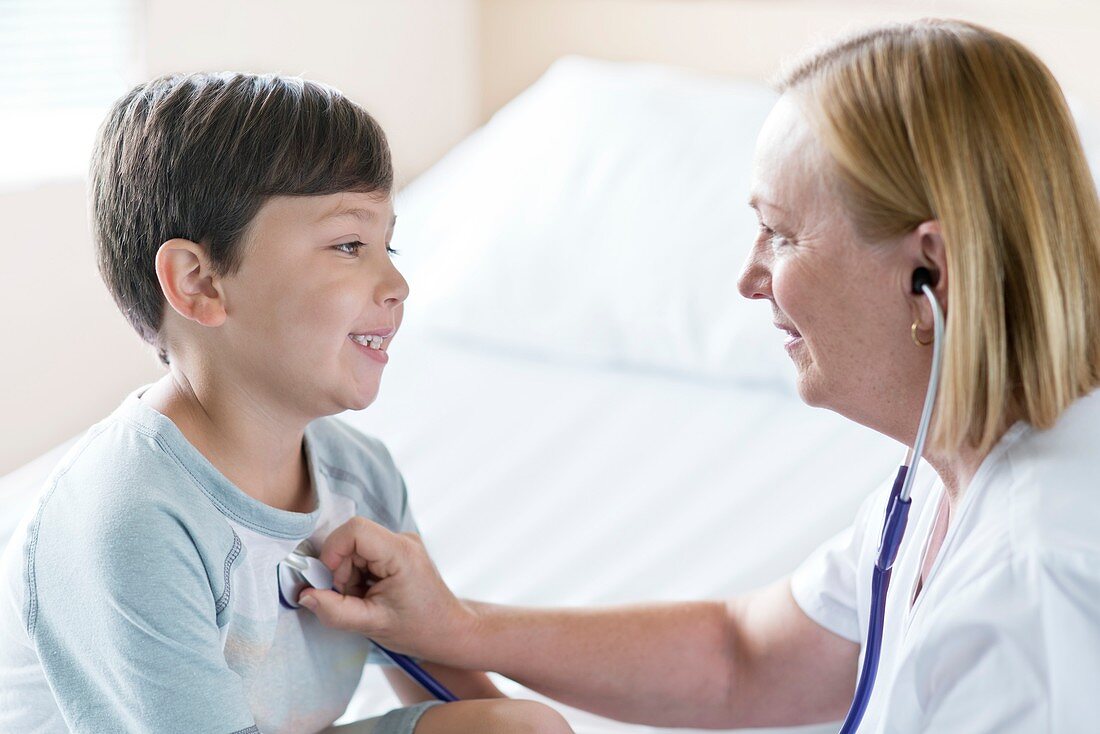 Boy smiling towards nurse with stethoscope