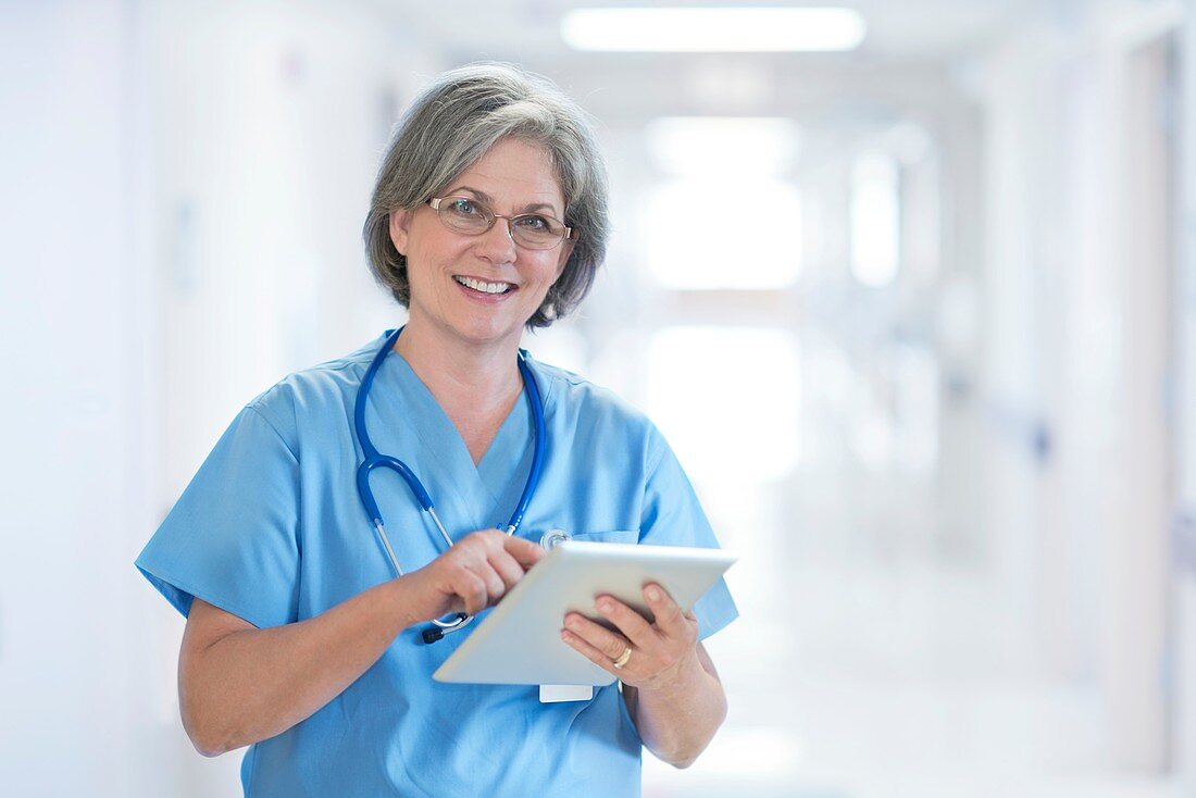 Mature female doctor using tablet