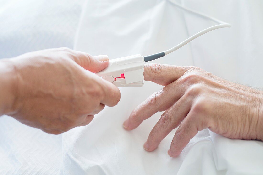 Nurse applying pulse oximeter