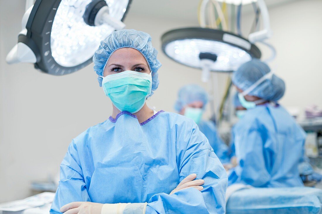 Female surgeon in scrubs and mask