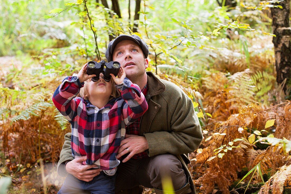 Father and son with binoculars