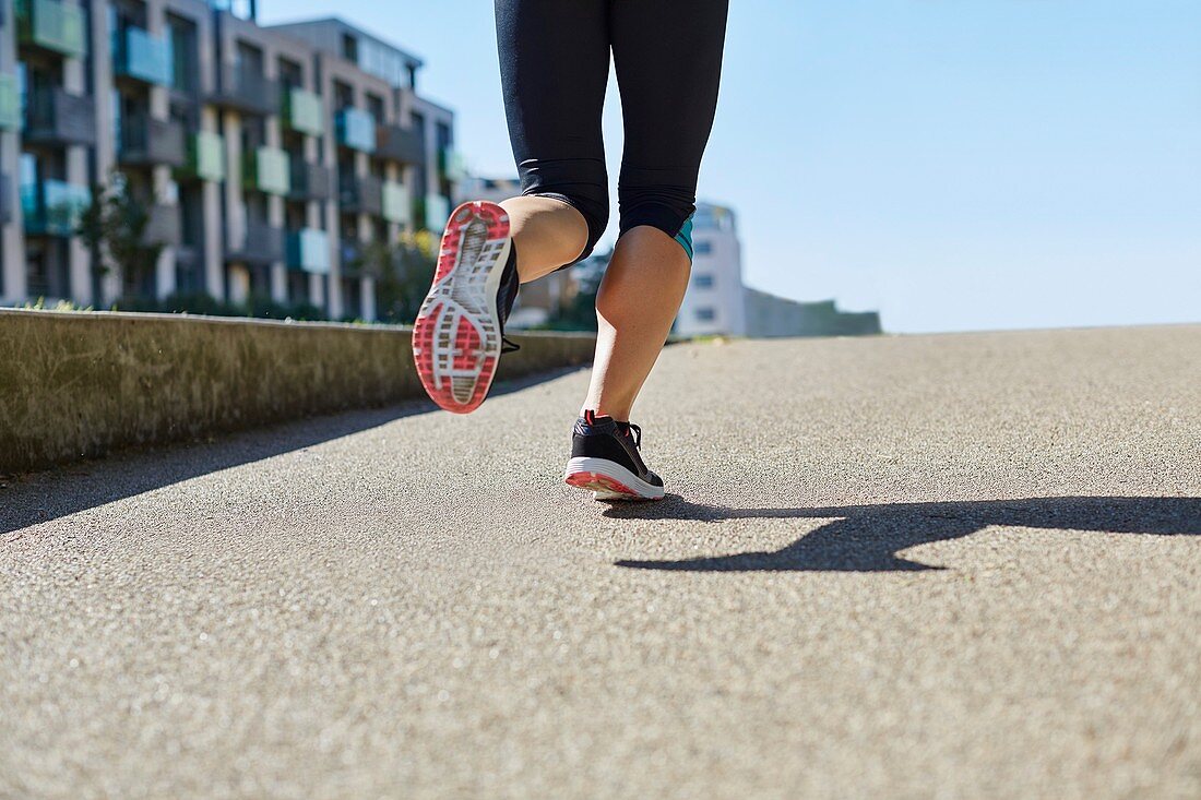 Woman jogging, low section