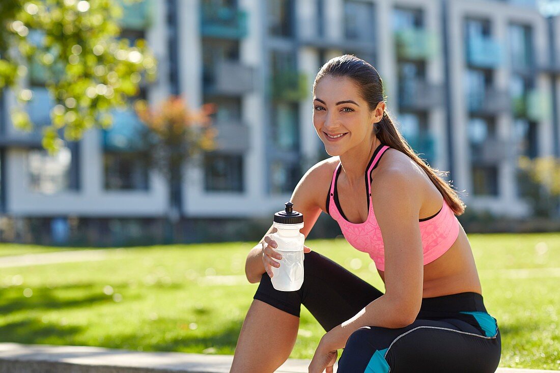 Young woman holding water bottle