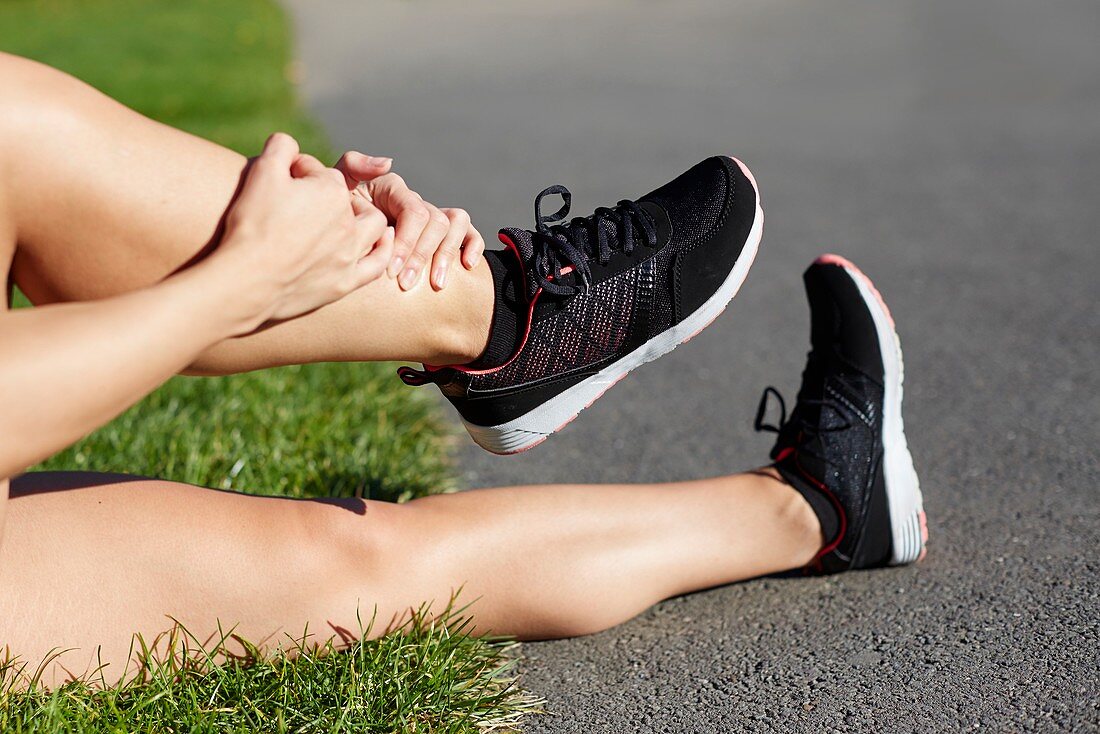 Woman holding her ankle