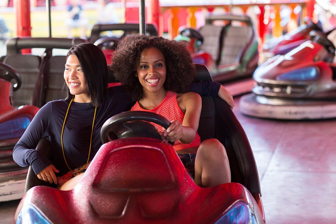 Women on bumper car at fun fair