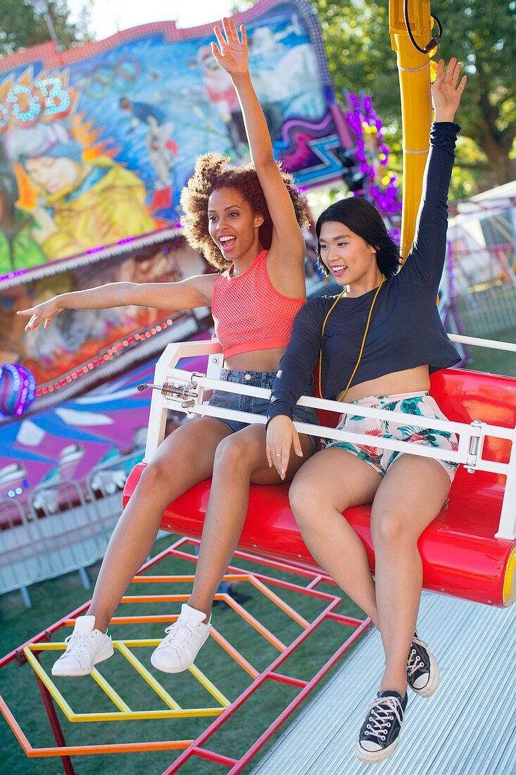 Women on fairground ride at fun fair