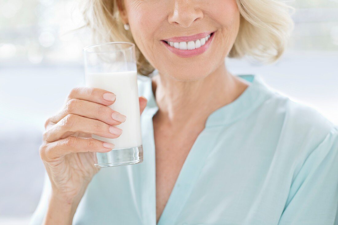 Mature woman smiling with drink